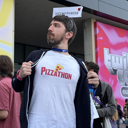 a member of G's community showing off the pizzathon tee outside TwitchCon Europe